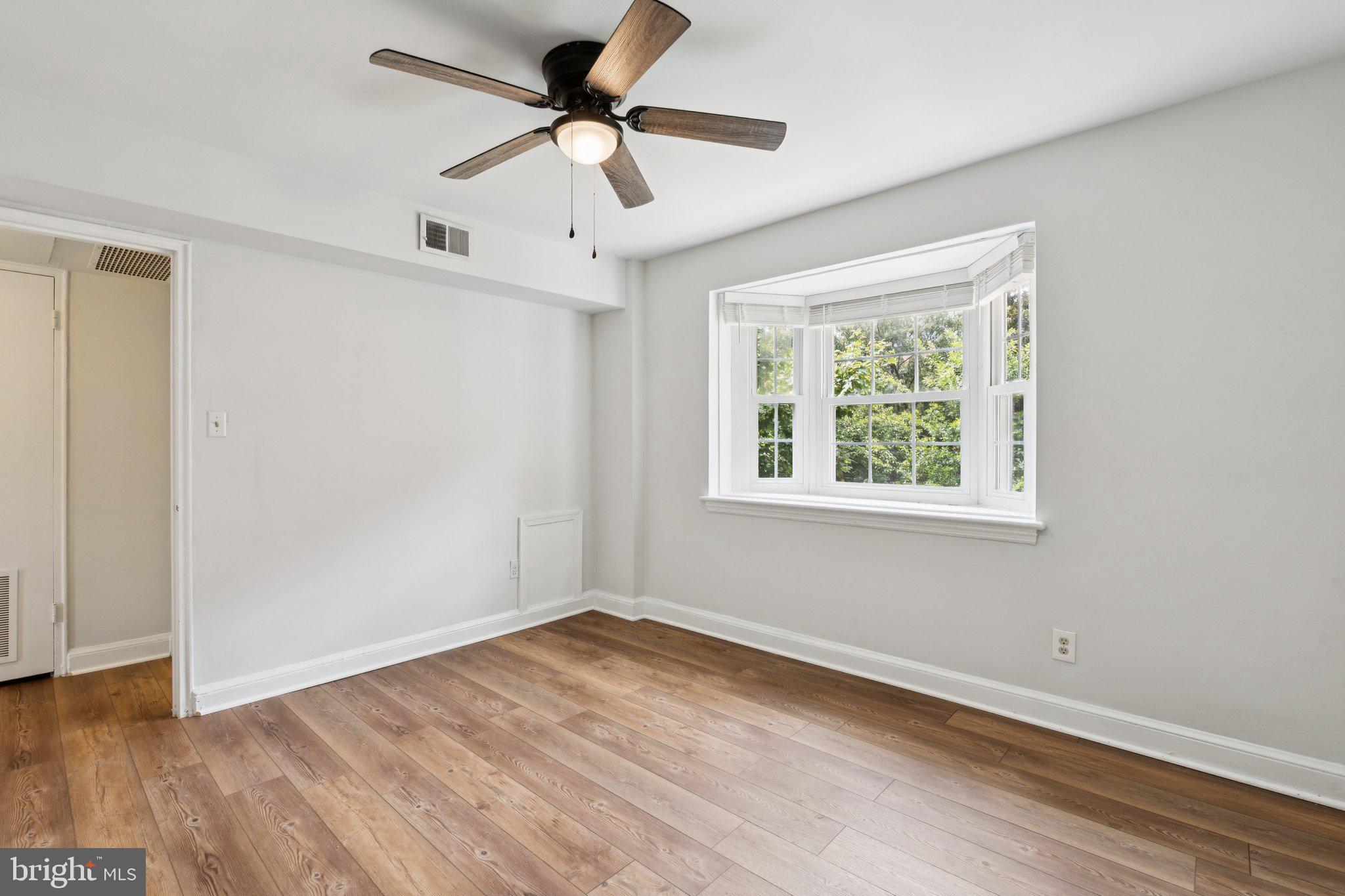 2107 North Scott Street, Unit 70 Arlington, VA 22209 - Photo 14 of 19 a view of empty room with wooden floor and fan