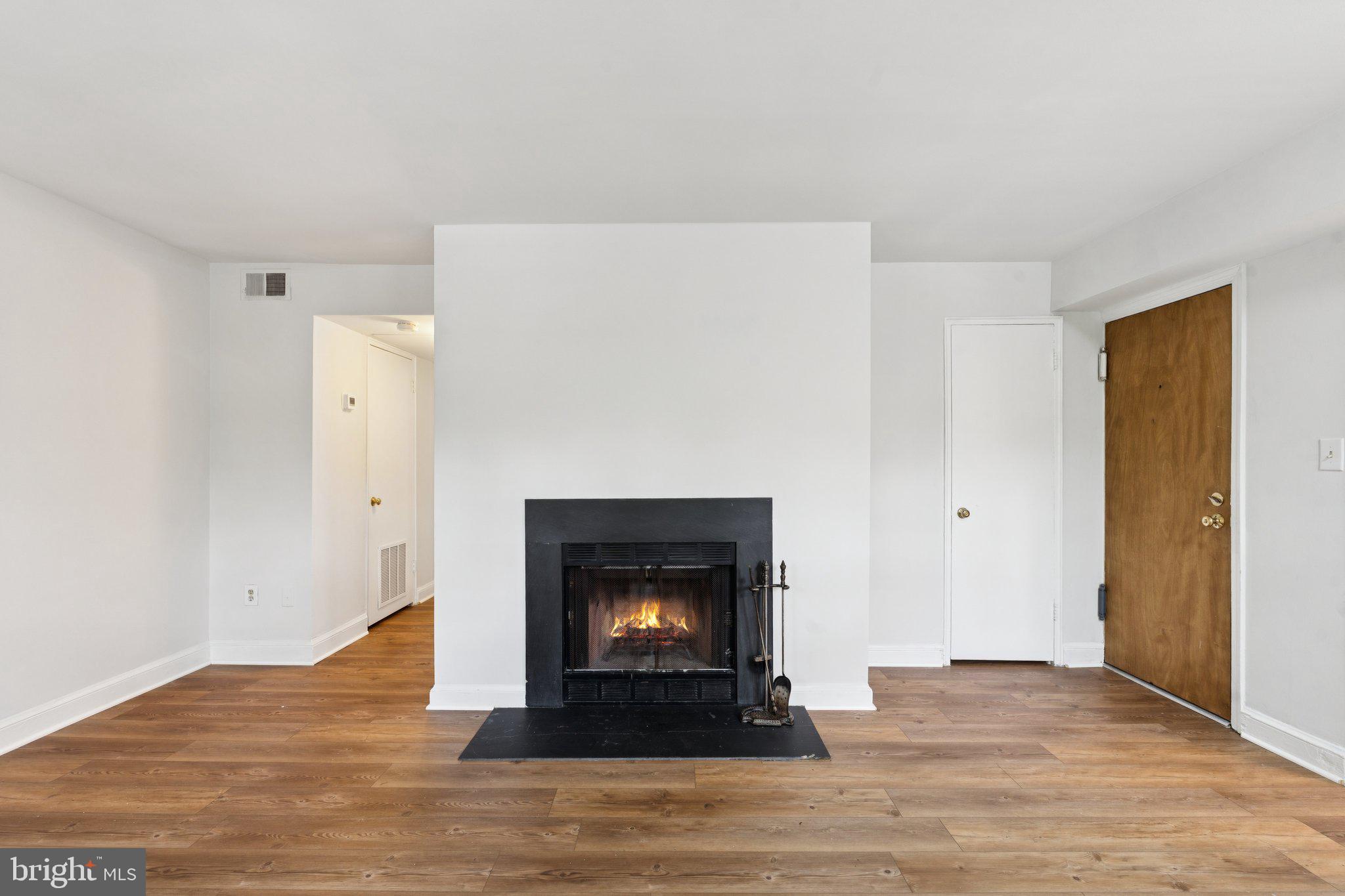 2107 North Scott Street, Unit 70 Arlington, VA 22209 - Photo 3 of 19 a living room with a fireplace