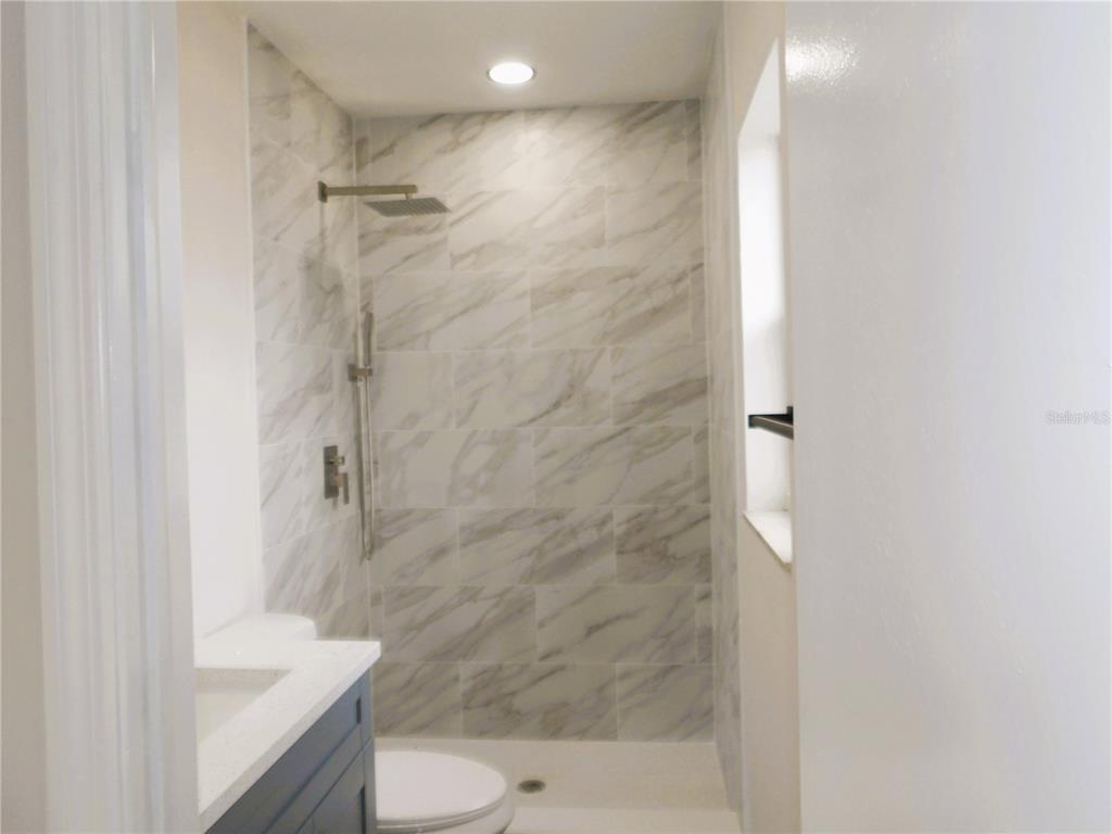 614 Huntington Street Brandon, FL 33511 - Photo 11 of 16 a bathroom with a sink a toilet and shower