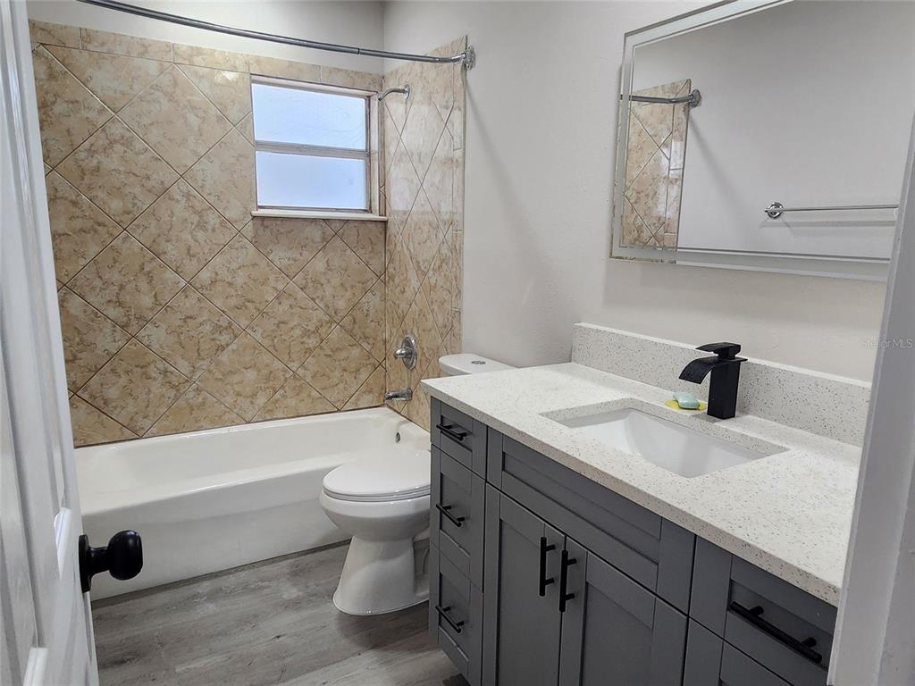 614 Huntington Street Brandon, FL 33511 - Photo 15 of 16 a bathroom with a sink a toilet and shower