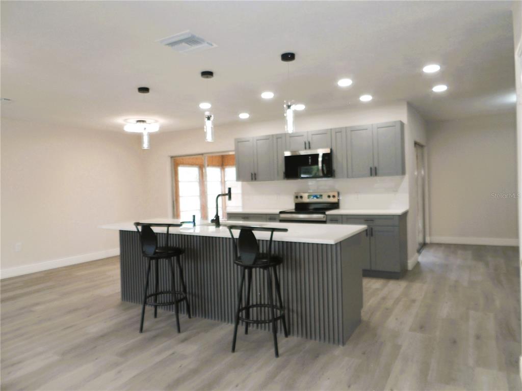 614 Huntington Street Brandon, FL 33511 - Photo 2 of 16 a kitchen with a sink cabinets and wooden floor