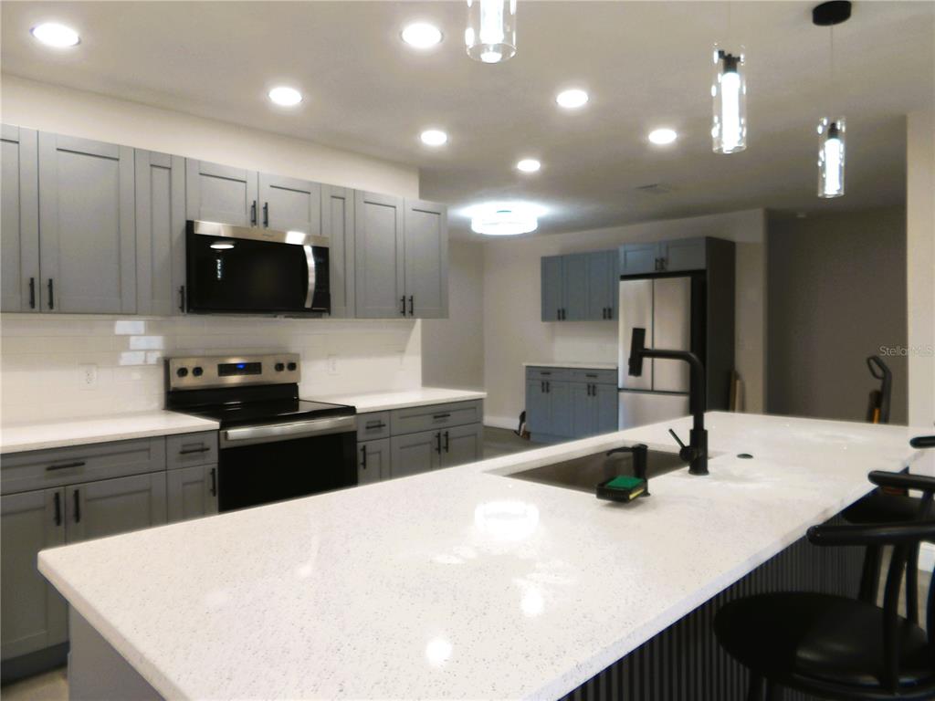 614 Huntington Street Brandon, FL 33511 - Photo 3 of 16 a kitchen with a sink a stove and refrigerator
