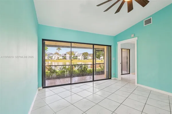 a view of a room with window and chandelier fan
