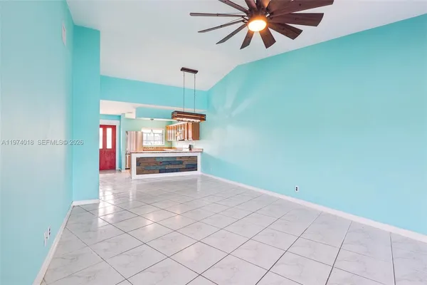 a view of an empty room with a fan