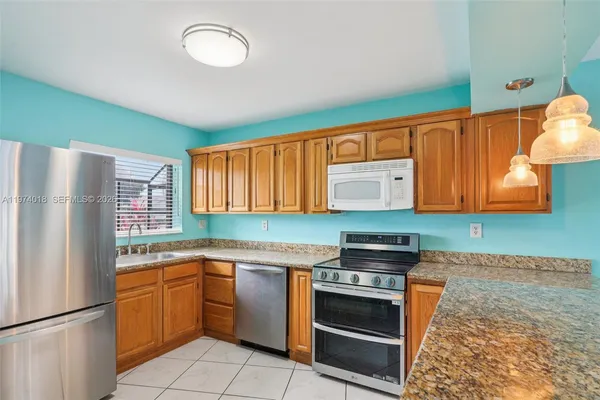 a kitchen with a sink stove and refrigerator