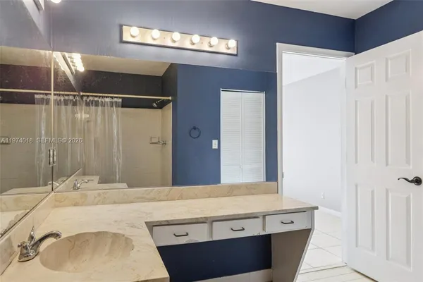 a bathroom with a sink and a mirror