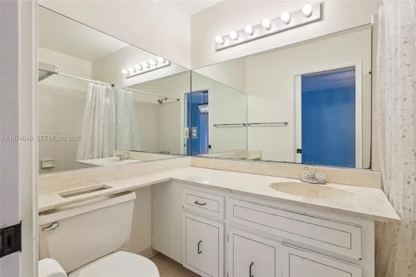 a bathroom with a sink a vanity and a mirror