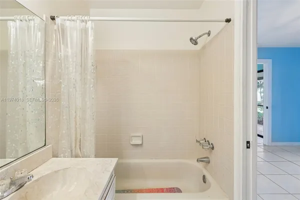 a bathroom with a tub and shower