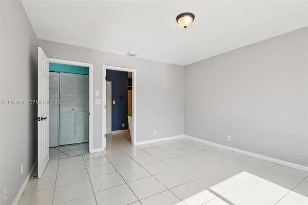 a view of an empty room with closet area