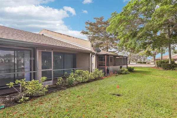 front view of a brick house with a yard