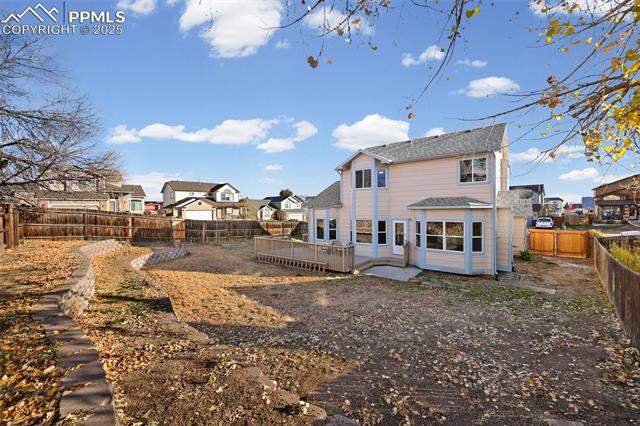 5428 Rondo Way Colorado Springs, CO 80911 - Photo 37 of 43 Rear view of house with a fenced backyard, a residential view, and a deck