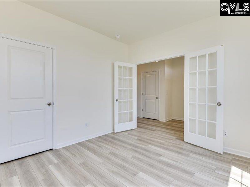 628 Old Charleston Road Pelion, SC 29123 - Photo 34 of 36 an empty room with wooden floor and closet area