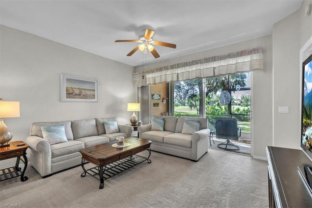 8075 Tiger Cove, Unit 1706 Naples, FL 34113 - Photo 3 of 50 Living room featuring ceiling fan and carpet