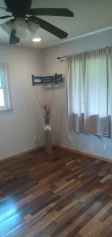 a view of a room with wooden floor