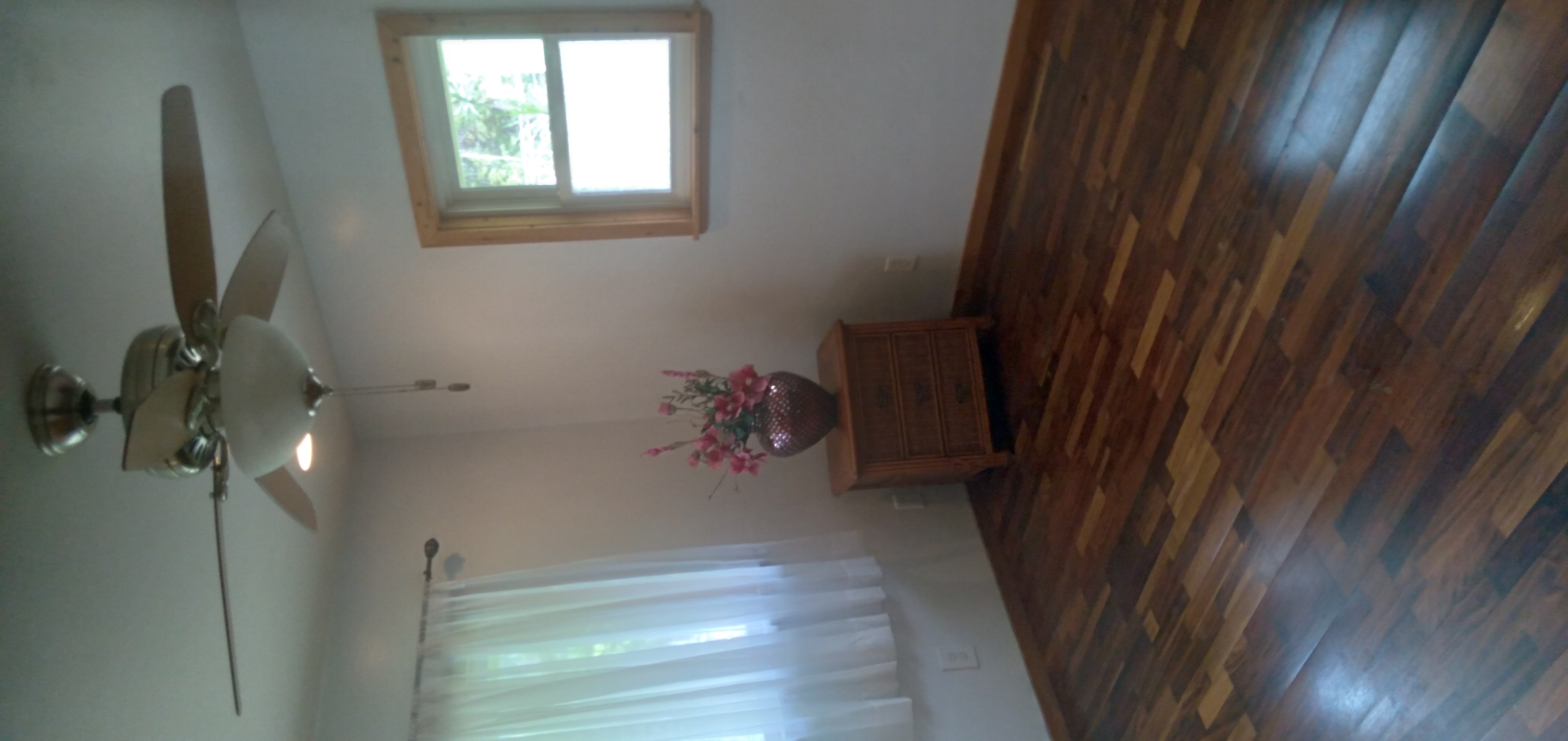 14-3431 Seadrift Road Pahoa, HI 96778 - Photo 17 of 22 a view of an empty room with wooden floor and a window