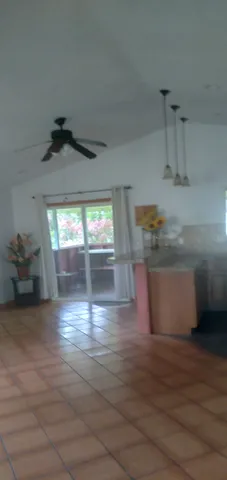 a view of a room with wooden floor and a window