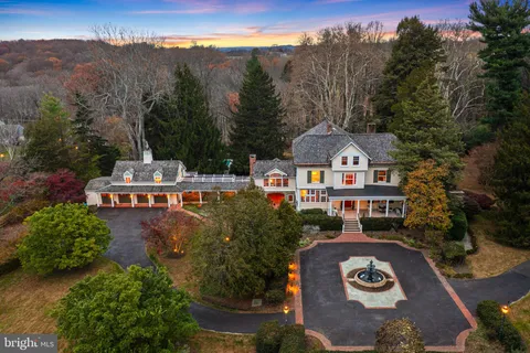 an aerial view of a house with a yard and lake view
