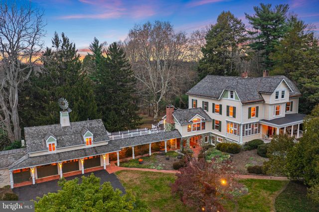 an aerial view of residential house with outdoor space and trees all around