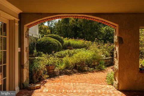 a living room with furniture a fireplace and a large window
