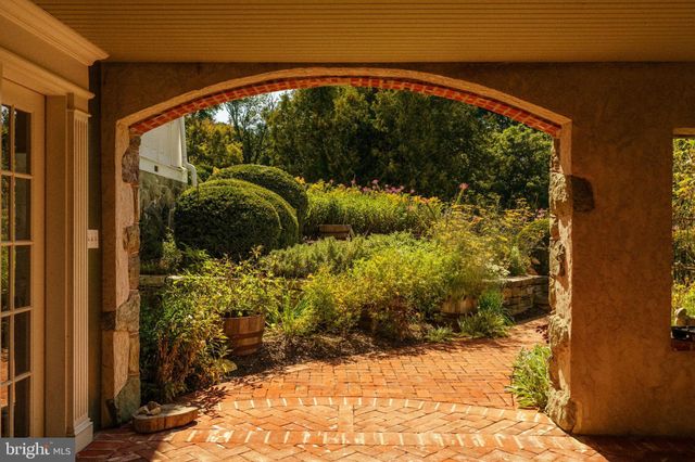 a living room with furniture a fireplace and a large window