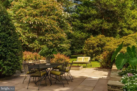 a living room with fireplace furniture and a large window