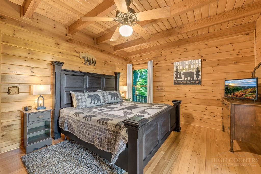 2229 Elk Ridge Road Ferguson, NC 28624 - Photo 23 of 42 a bedroom with a bed and wooden floor