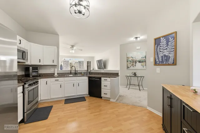 a living room with furniture ceiling fan and a flat screen tv