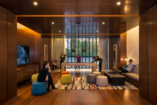 a living room with furniture and floor to ceiling window