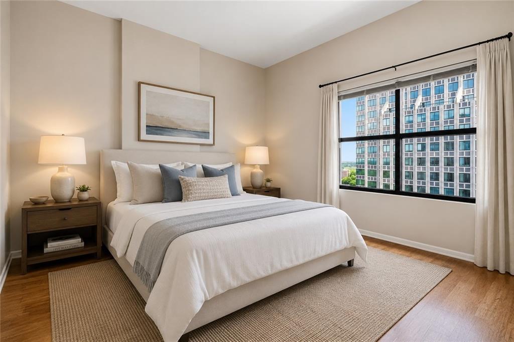 3040 Peachtree Road Northwest, Unit 1503 Atlanta, GA 30305 - Photo 13 of 38 a bedroom with a large bed and a lamp next to a window