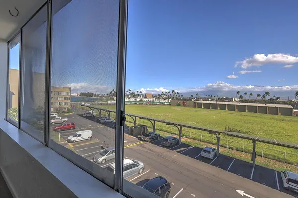 a view of swimming pool from a balcony with lake view and ocean view