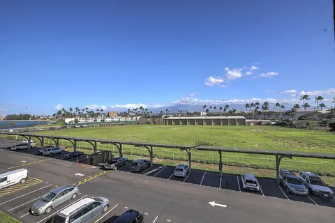 a view of a city street view with lawn chairs and ocean view
