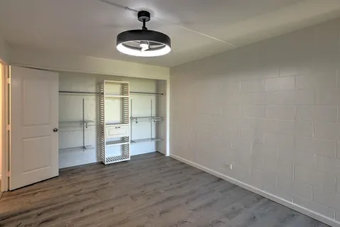 an empty room with a empty space and wooden floor