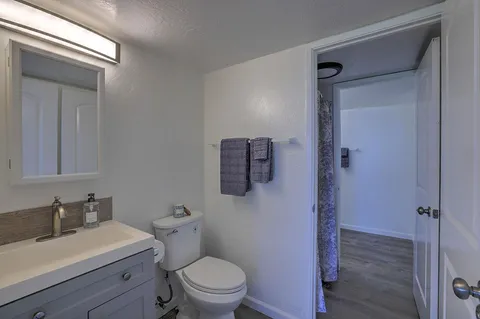 a bathroom with a toilet a sink and mirror