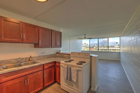 a kitchen with stainless steel appliances granite countertop a sink stove and cabinets
