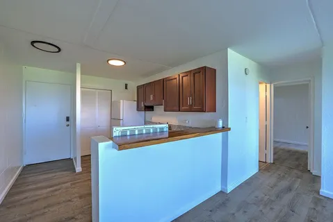 a kitchen with stainless steel appliances granite countertop a refrigerator and a stove