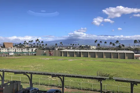 a view of a big yard with table and chairs