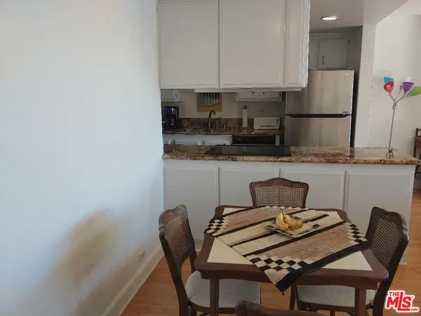 a kitchen with granite countertop a stove sink and cabinets