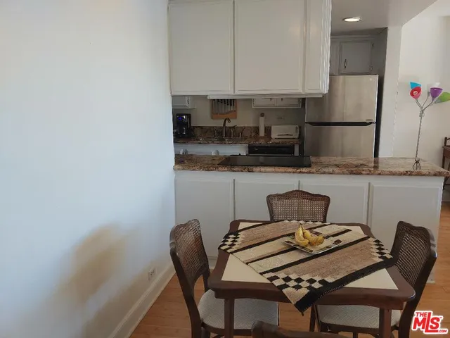 a kitchen with granite countertop a stove sink and cabinets