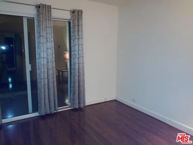 a bathroom with a granite countertop sink mirror and a toilet