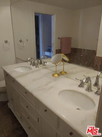 a bathroom with a toilet a sink and a mirror