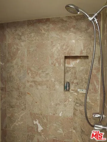 a bathroom with a shower and a shower head