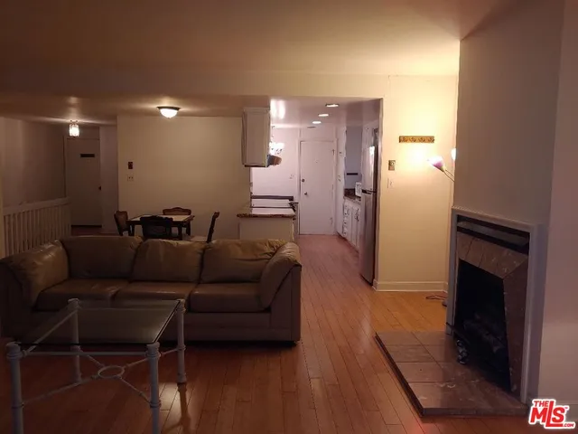 a living room with furniture a lamp and a fireplace