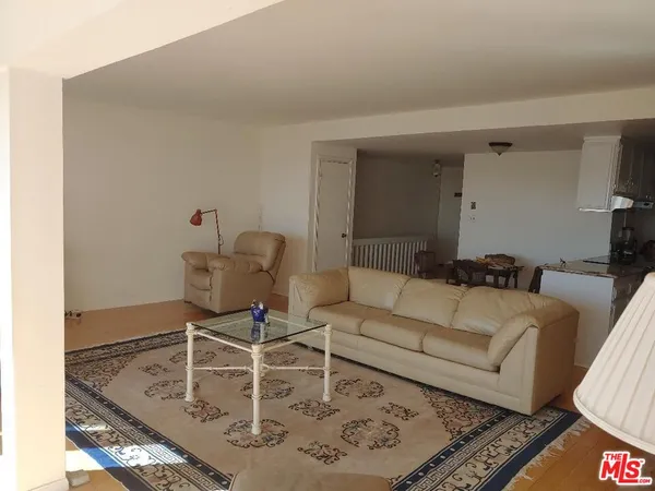 a view of a room with furniture and a window