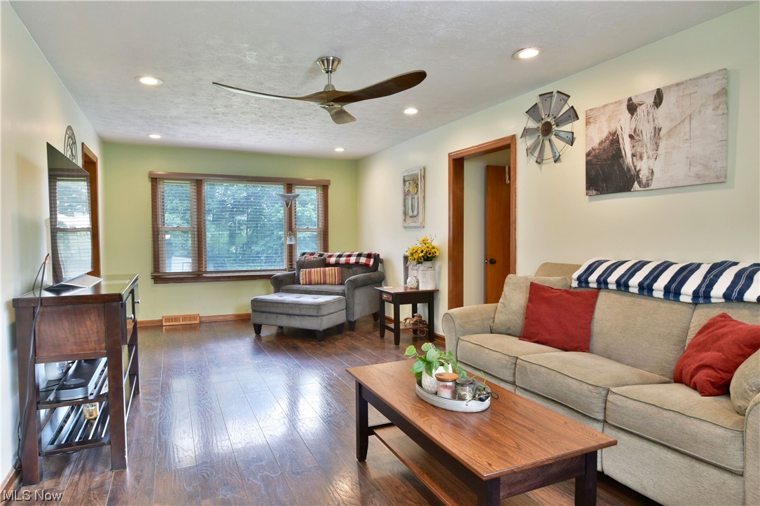 1711 Salt Springs Road Mineral Ridge, OH 44440 - Photo 17 of 35 Hardwood floored living room with ceiling fan