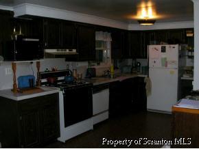 853 Spring Hill Road Sterling, PA 18463 - Photo 3 of 5 a kitchen with a sink and cabinets