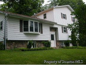 853 Spring Hill Road Sterling, PA 18463 - Photo 4 of 5 a front view of a house with a garden