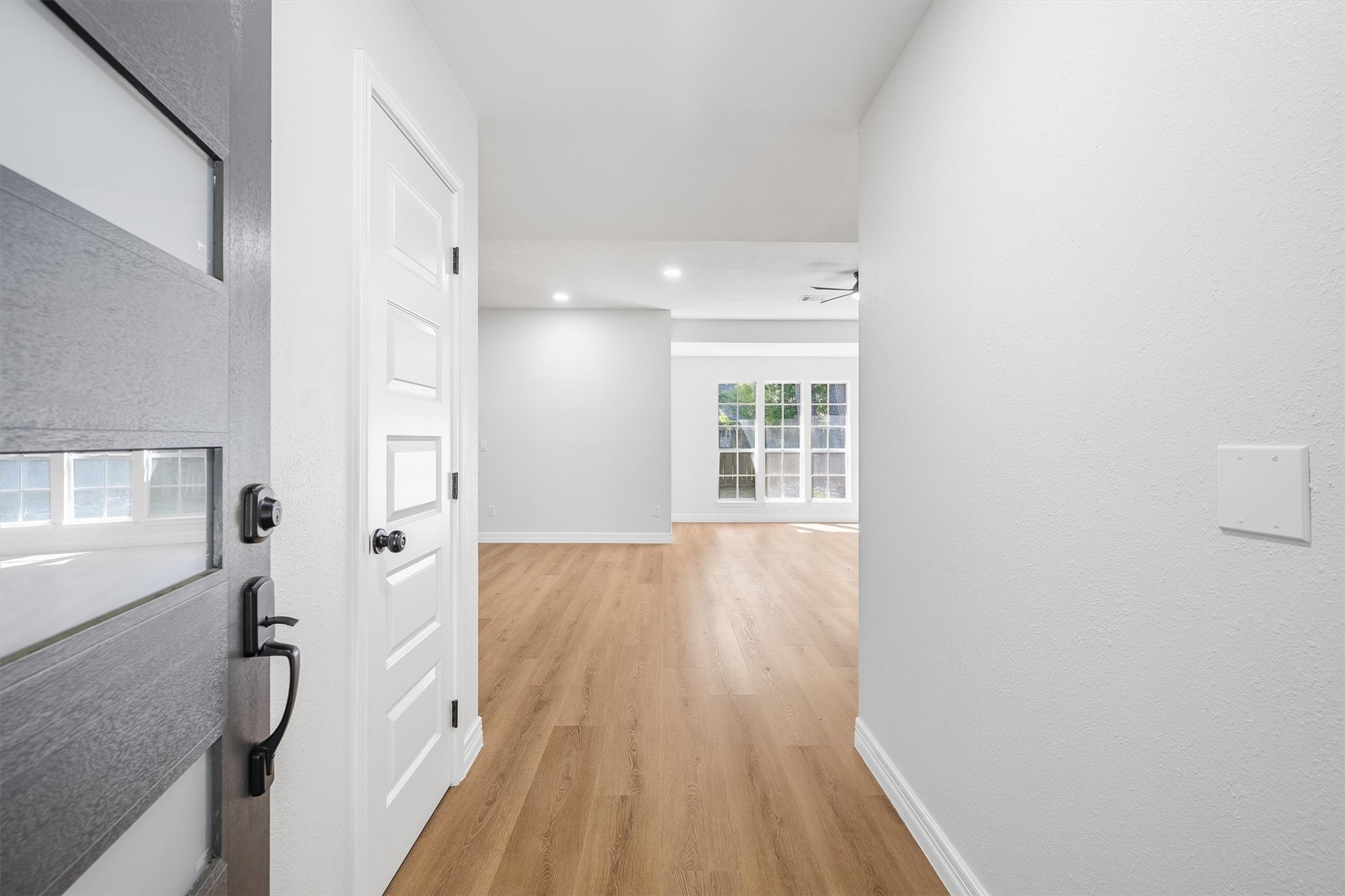 3 Still Corner Place Spring, TX 77381 - Photo 5 of 34 Just inside, the entry opens straight into a bright living space, where fresh vinyl plank flooring and natural light from a large window set an inviting tone for what's ahead.
