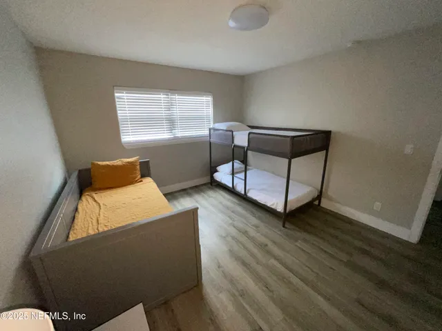 a view of a room with wooden floor and chair