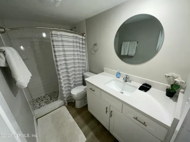 a bathroom with a shower and a toilet