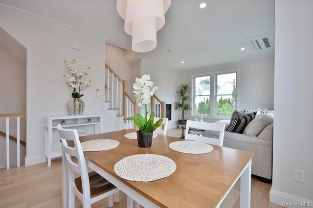 a view of a dining room with furniture and a chandelier